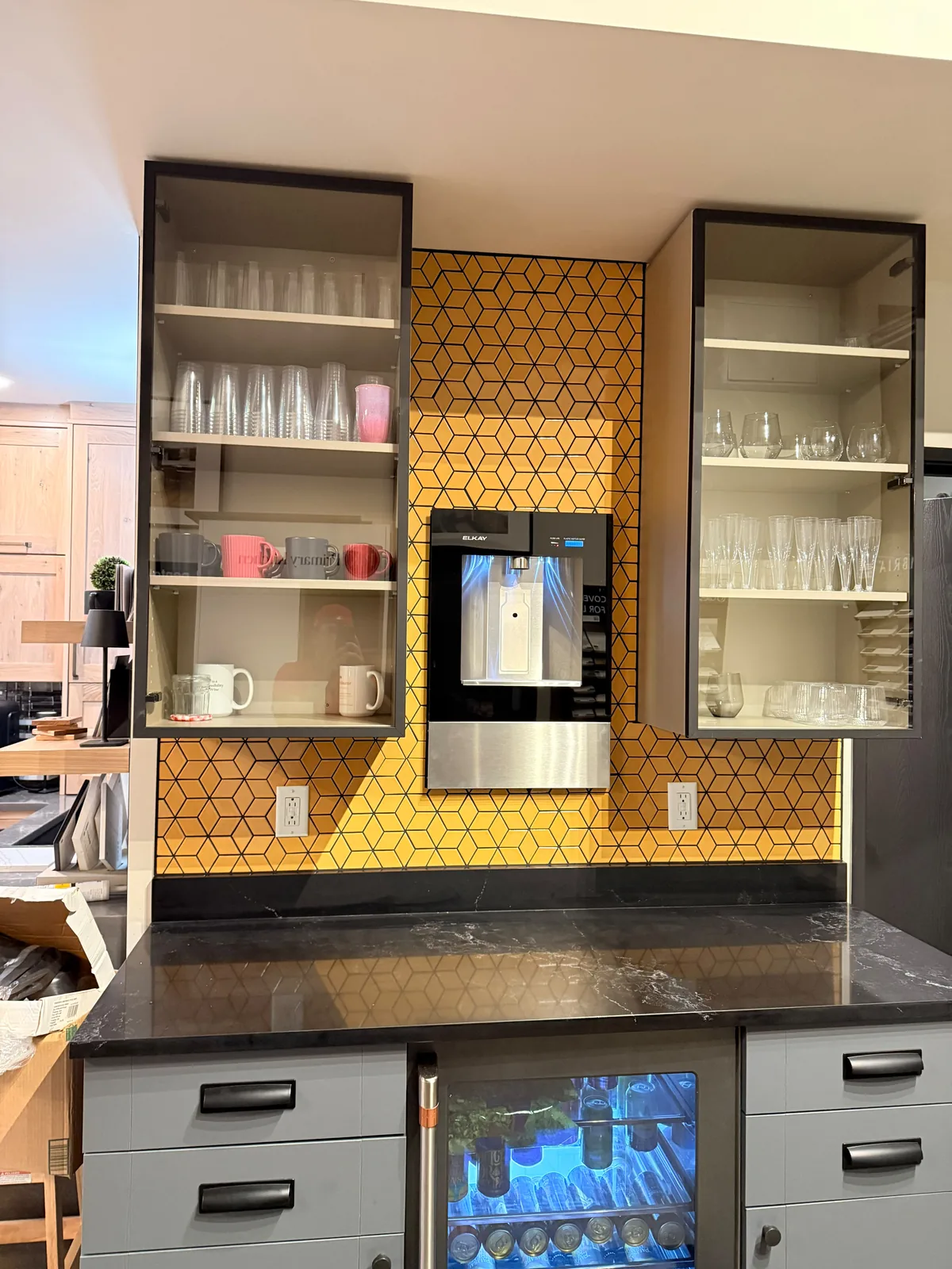 Bar with hexagon mosaic tile front and black quartz counter