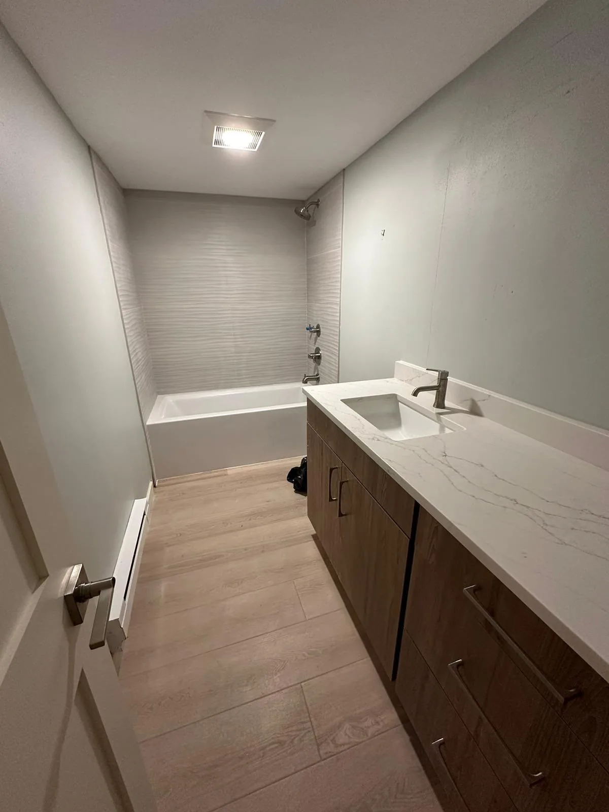 Finished bathroom with quartz vanity and new fixtures