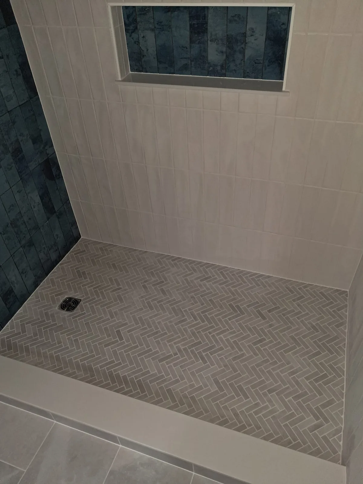Herringbone marble shower pan installed and drying