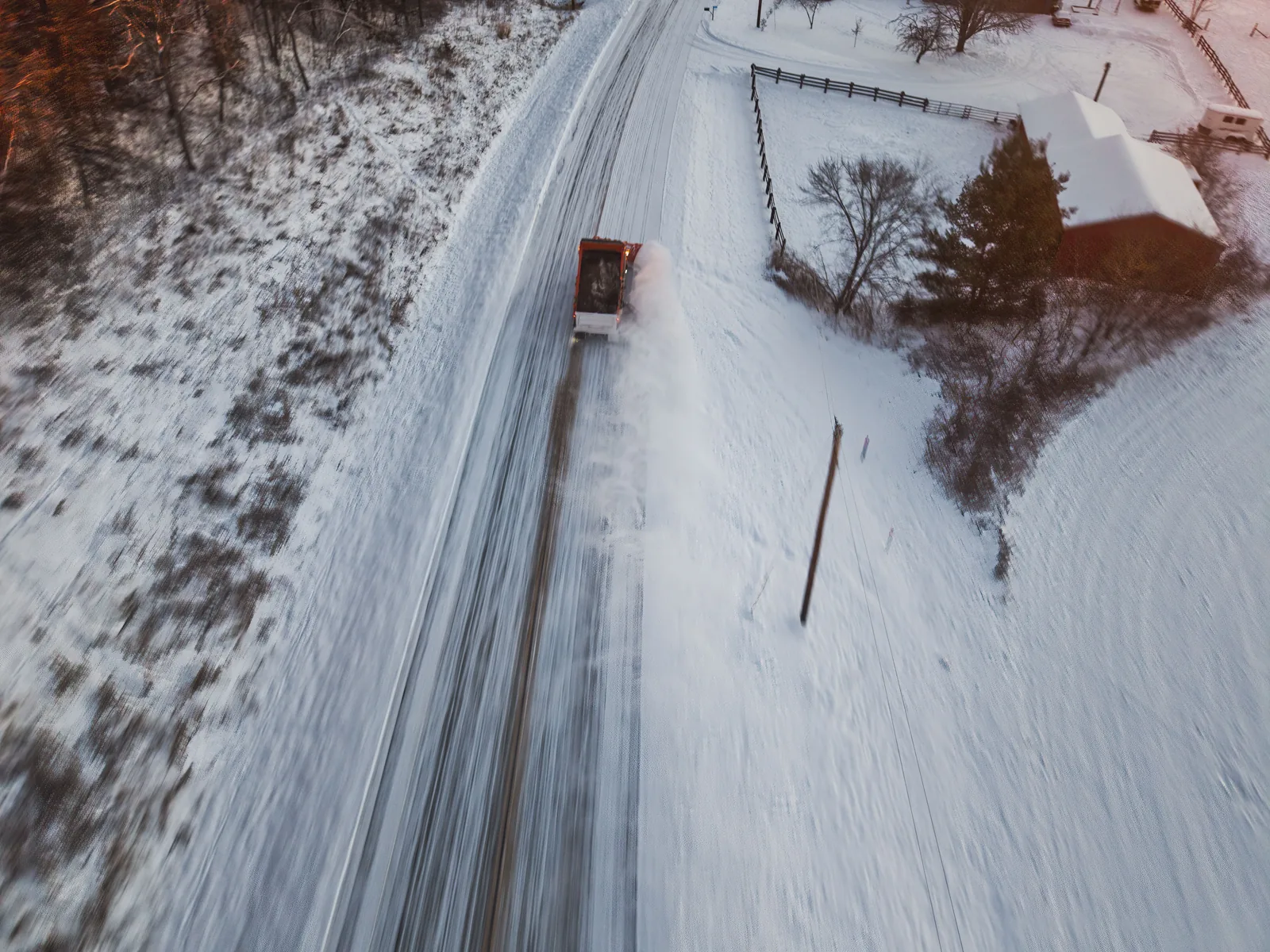 Snow-covered driveway and road after a winter storm